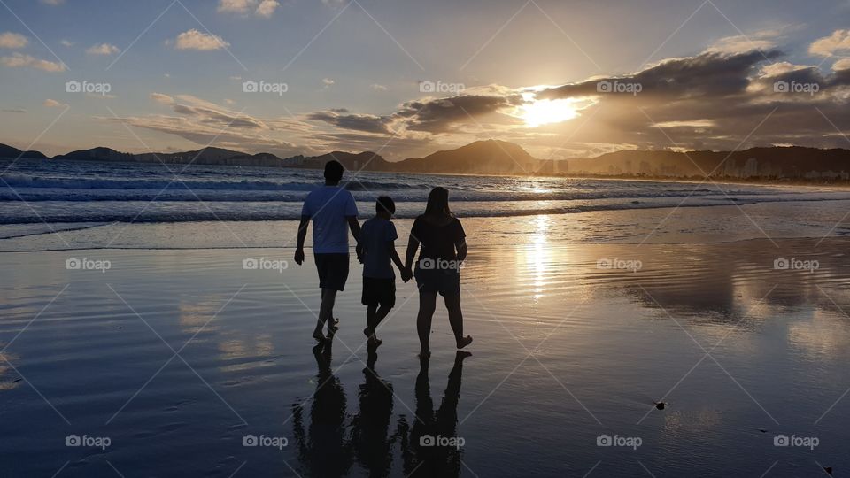 Family at Enseada Beach in Brazil during sunset