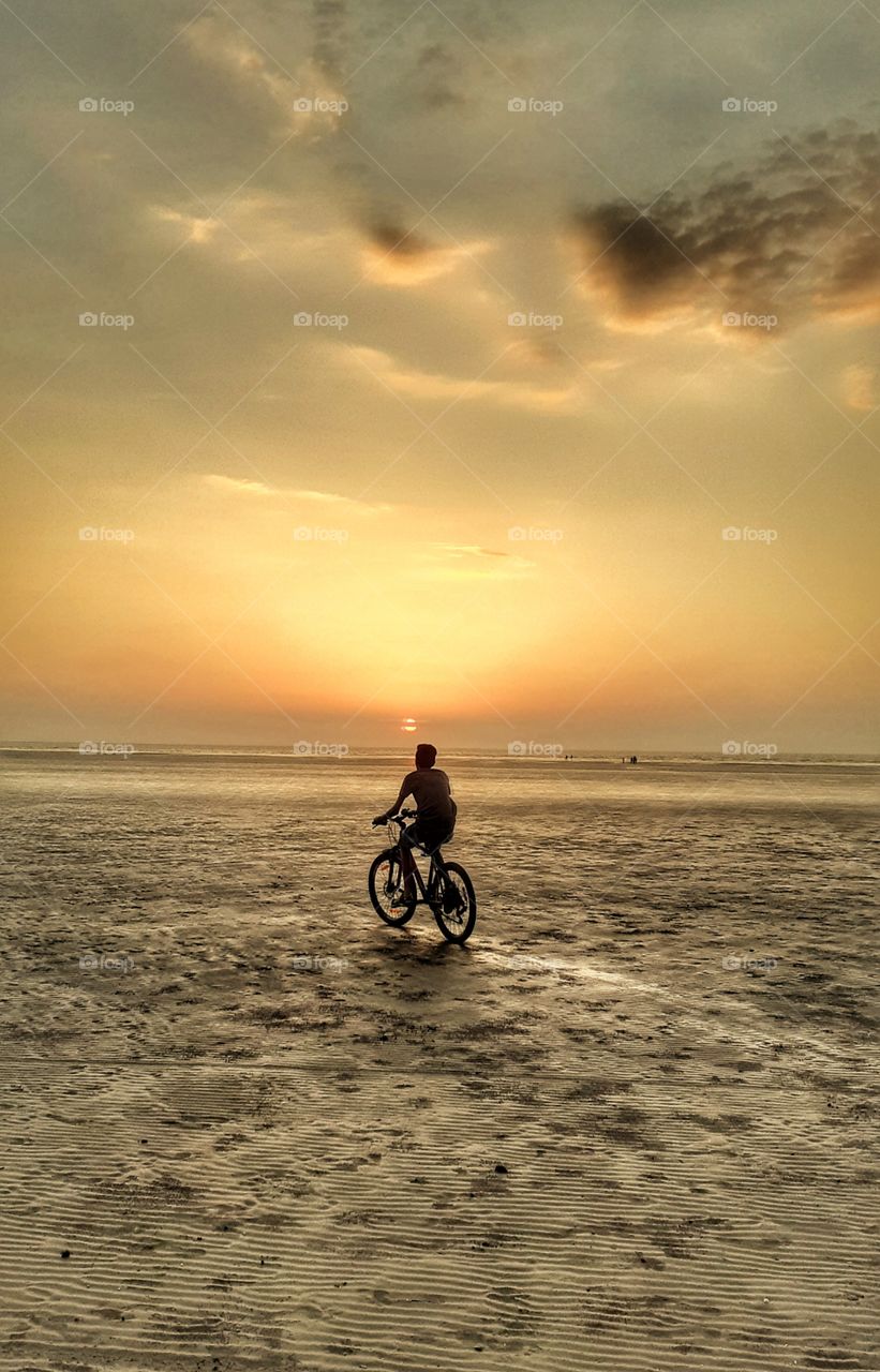 alone cycling on empty beach
