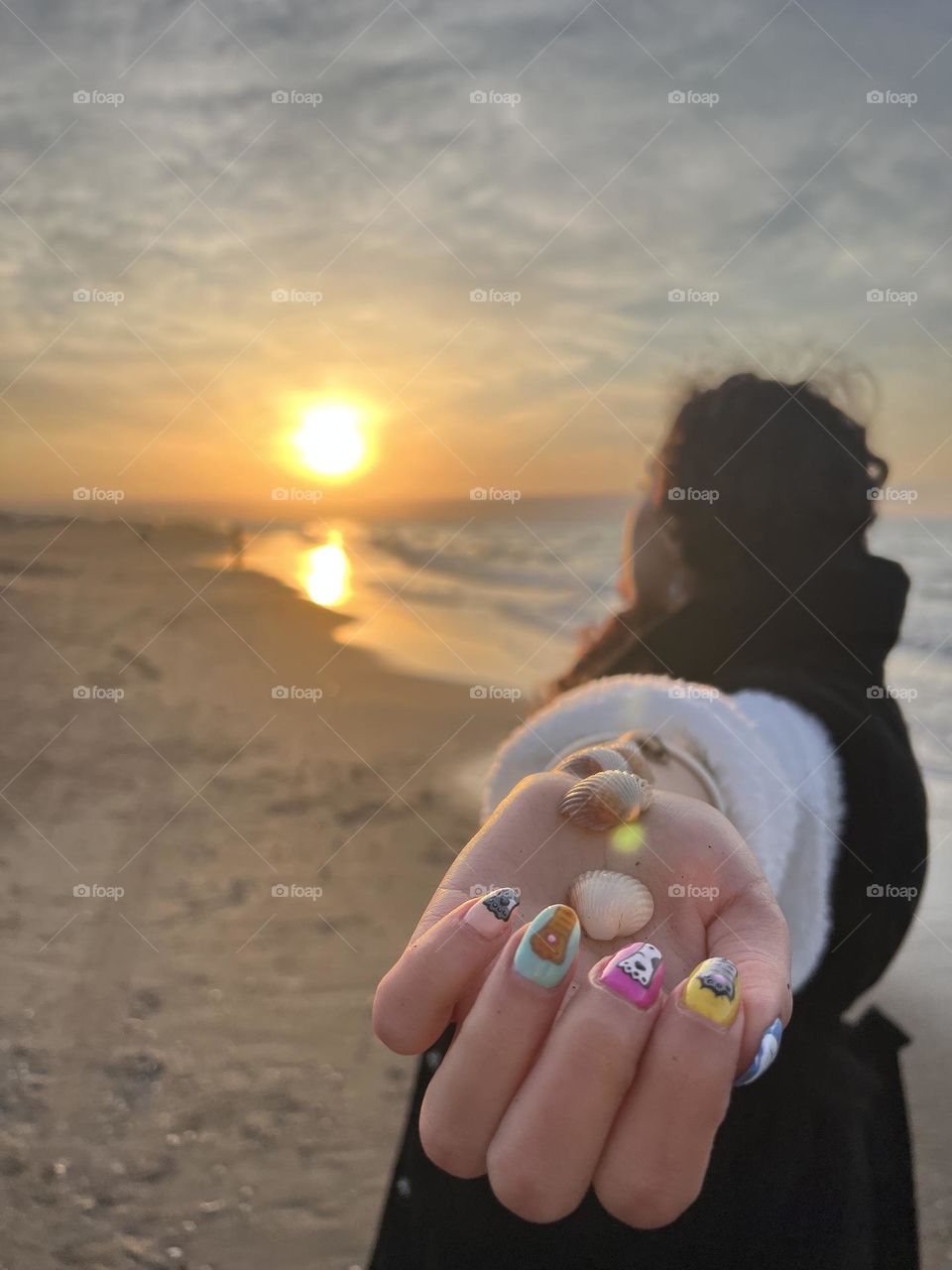 Curly haired girl watching the sunset