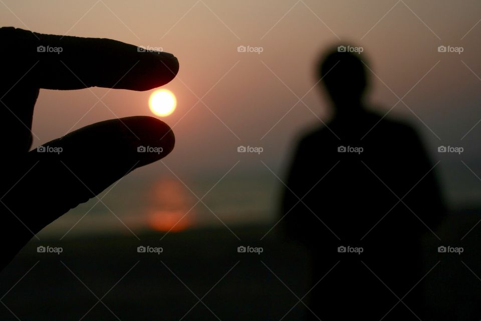 Playing with sun at beach 