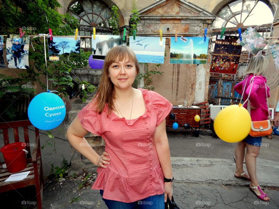 Woman is at a photo exhibition