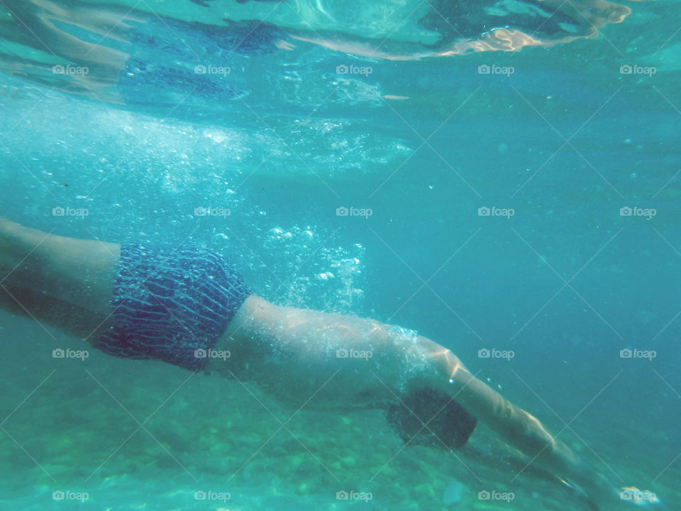 man swimming underwater. man jump in sea and swimming underwater