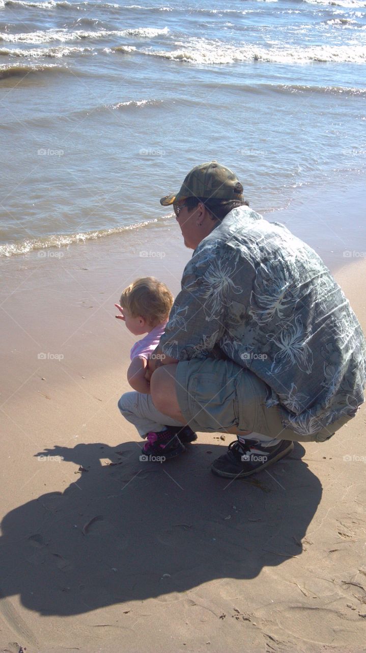 Grandpa and granddaughter at the beach