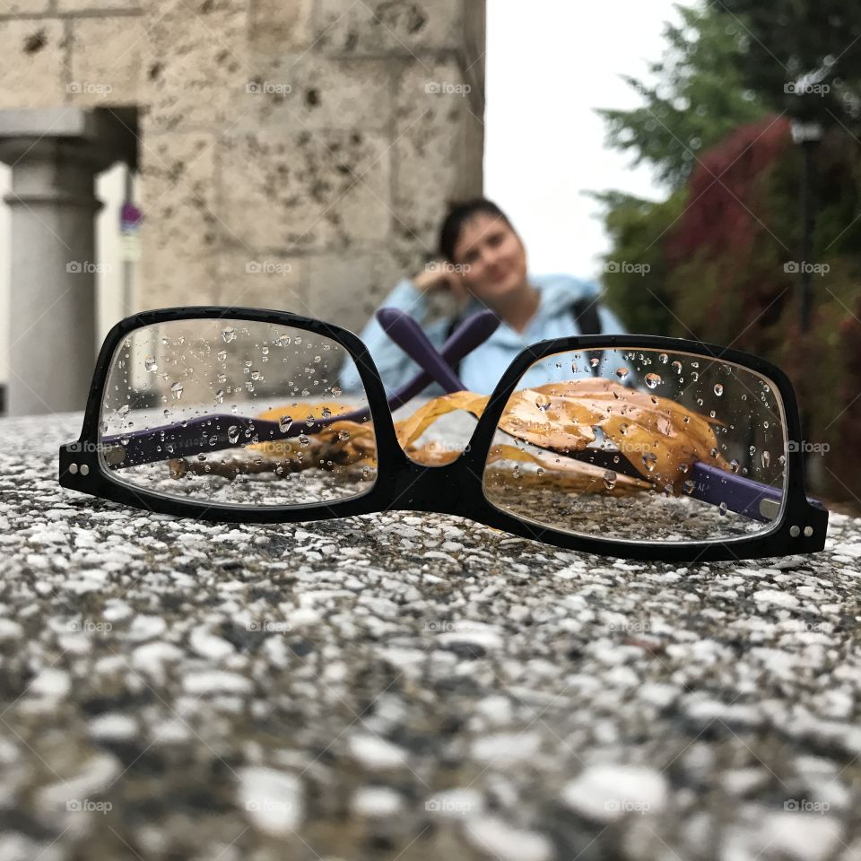 Eyeglasses with rain drops in rainy autumn cold day close up.