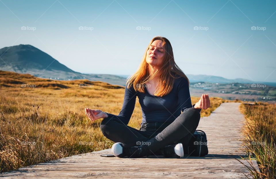 Happy girl meditating in nature