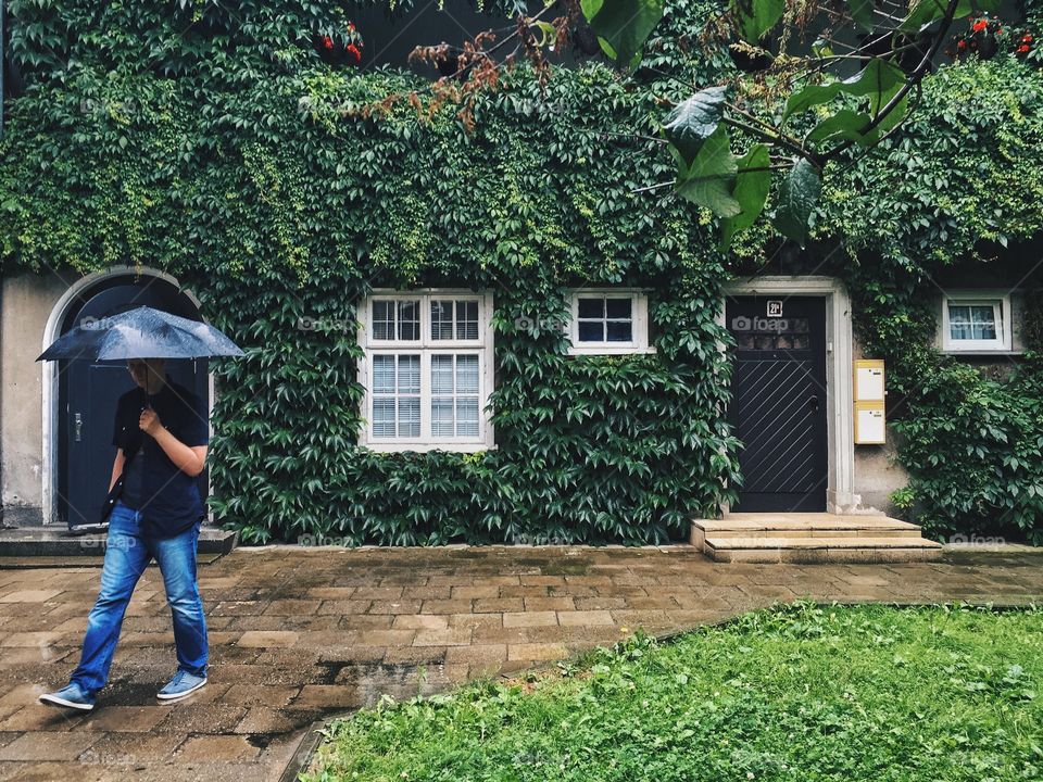 Man walking with black umbrella