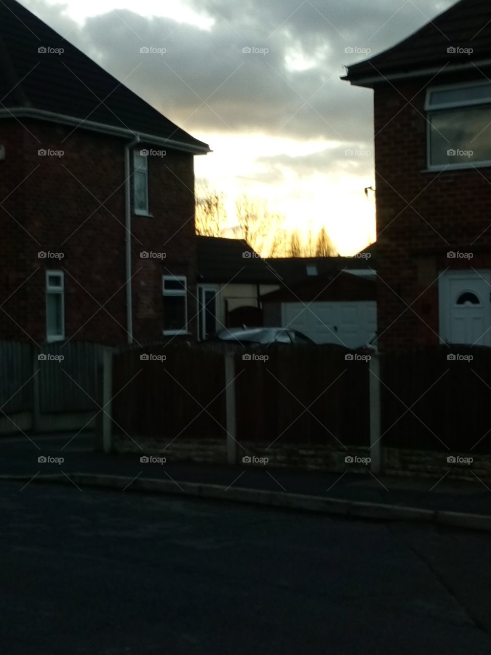 sunset in between houses