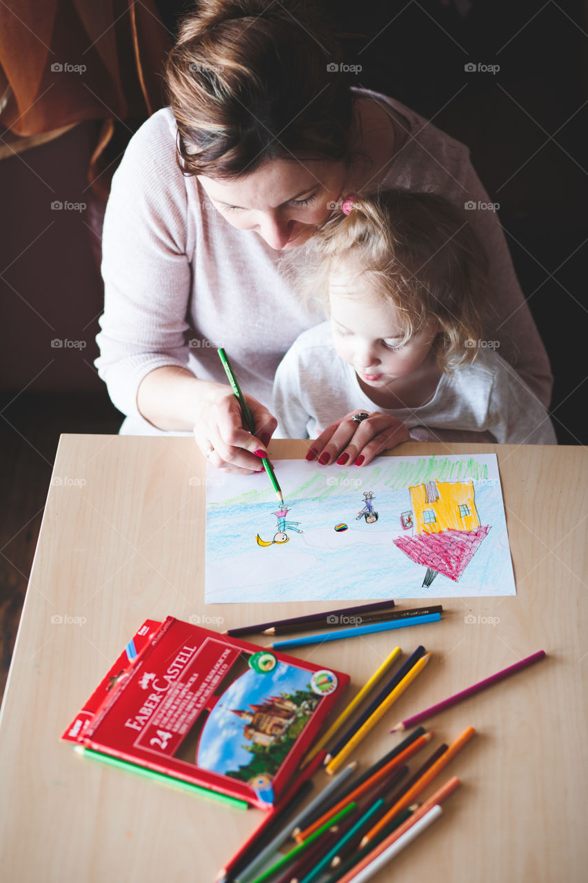 Colours of the world. Children with mom drawing using crayons