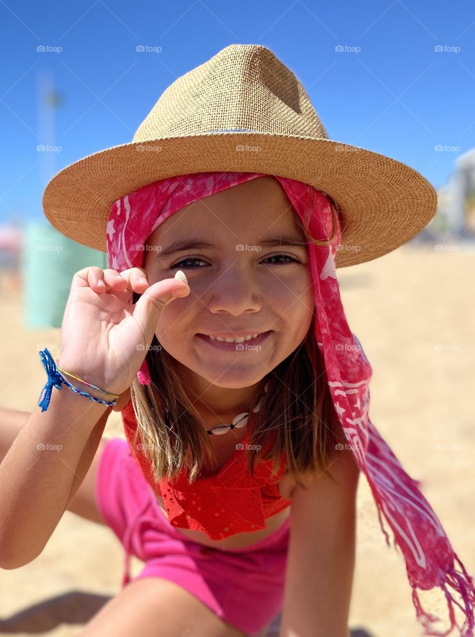 Little girl showing a small shell