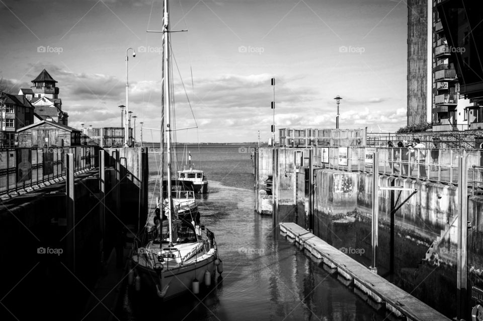 Sailboats moored at port