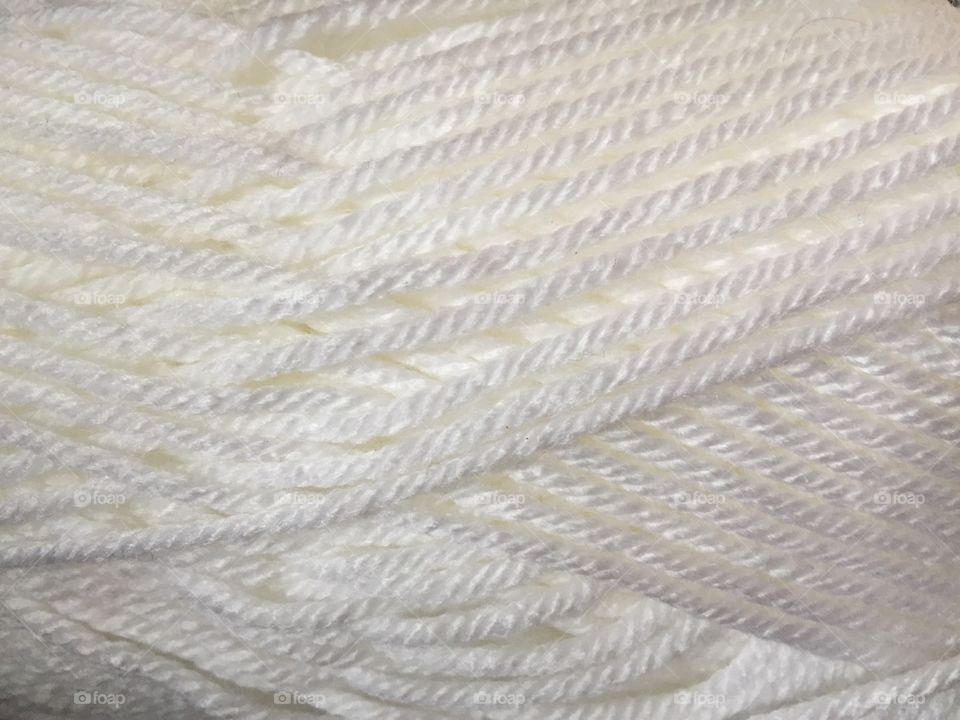 Close up of a white ball of yarn. 