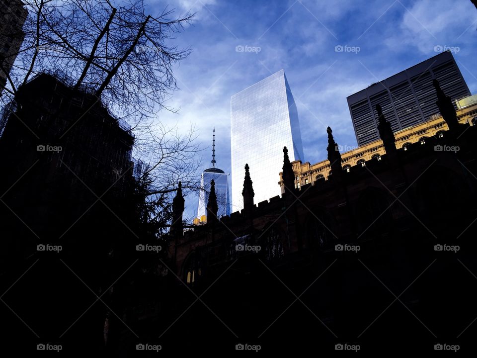 Old and new. Trinity Church in the shadow of the Freedom Tower -New York City 