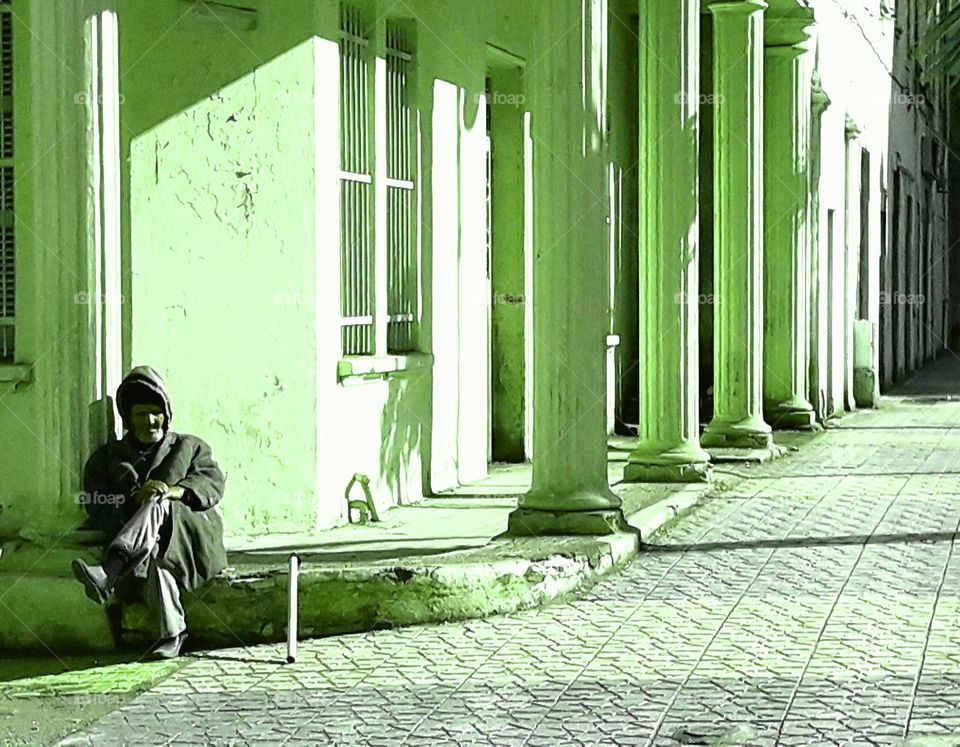 Old man sitting.. is he homeless?  i don't know.. but he looks like a poor one.. he have a family or not ? .. he is sad.. why?..