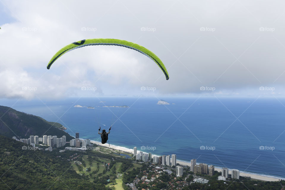 Paraglider flying over Sao Conrrado in Rio de Janeiro Brazil.