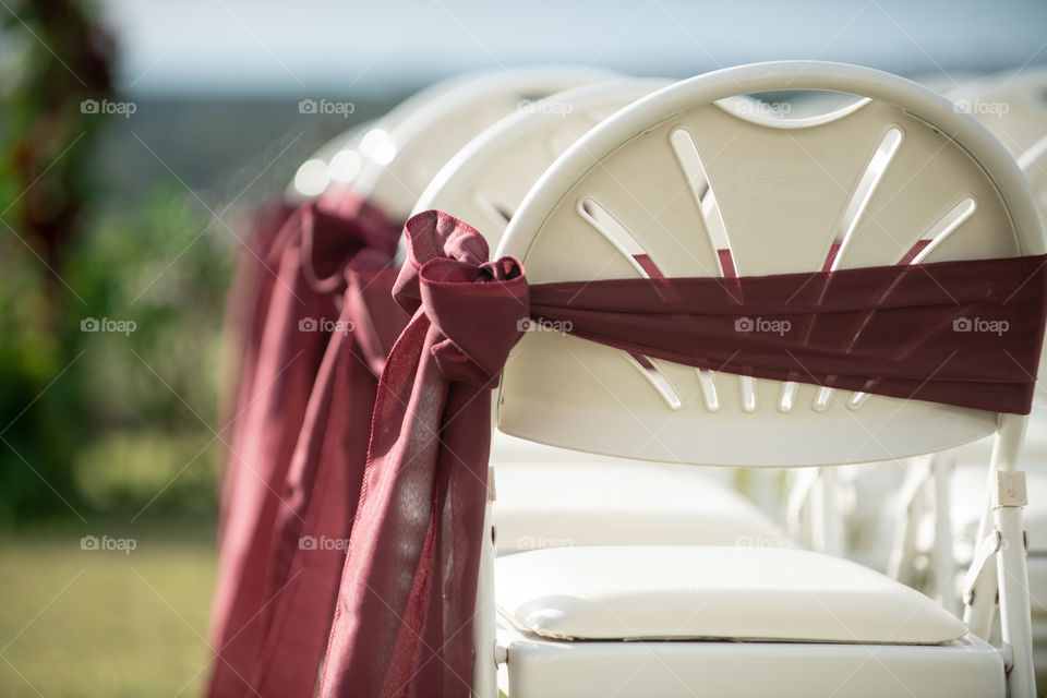 Red Bows and Ribbons on White Wedding Ceremony Chairs