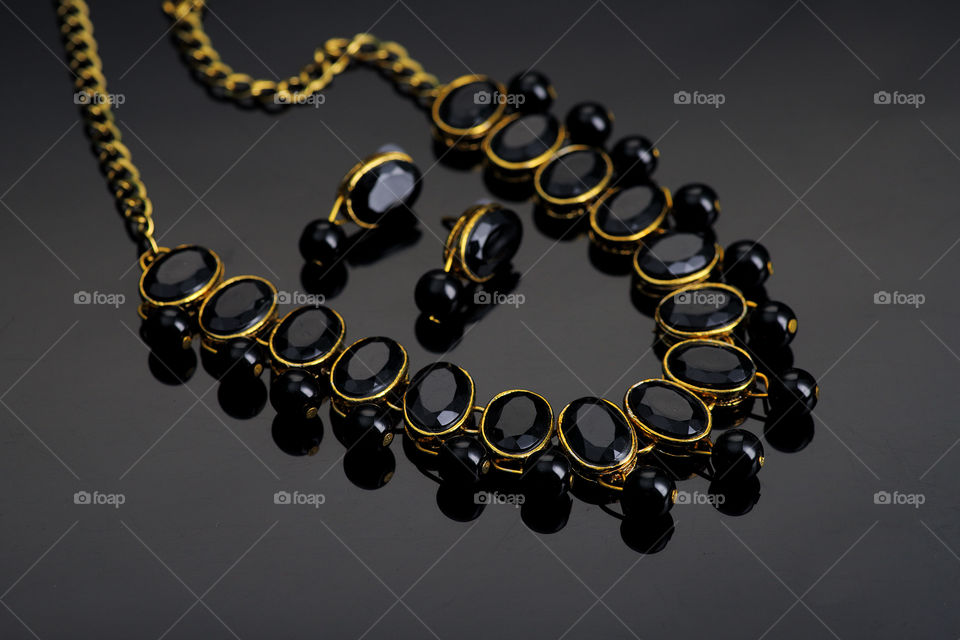 black stone jewelry set in black background