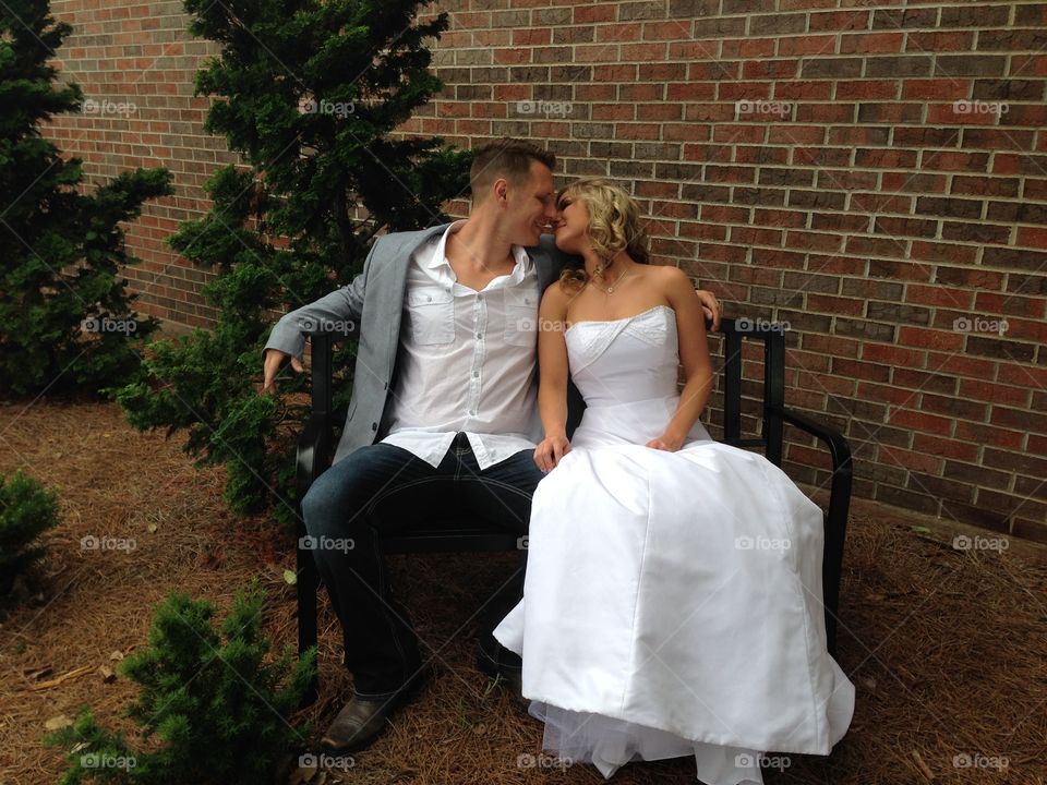 wedding kiss. Couple kissing an a bench