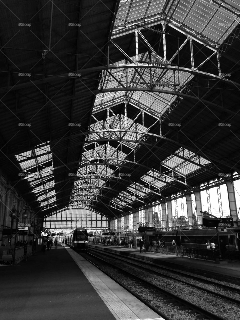 black and white photo of a train station in france