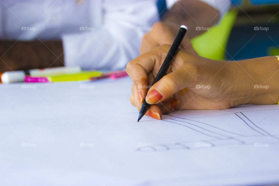 Lady drawing a plan on white sheet