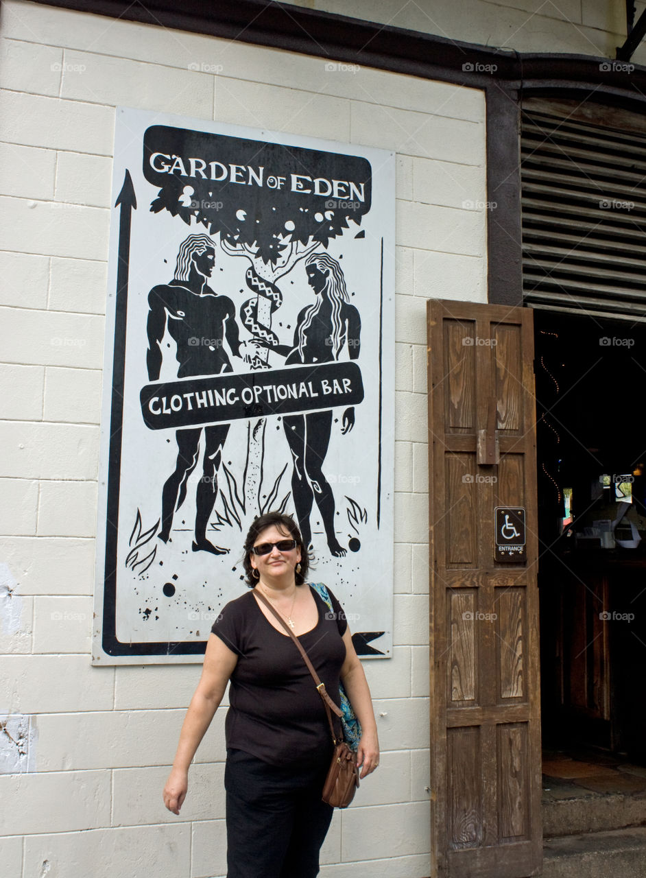 Smiling woman standing outside restaurant