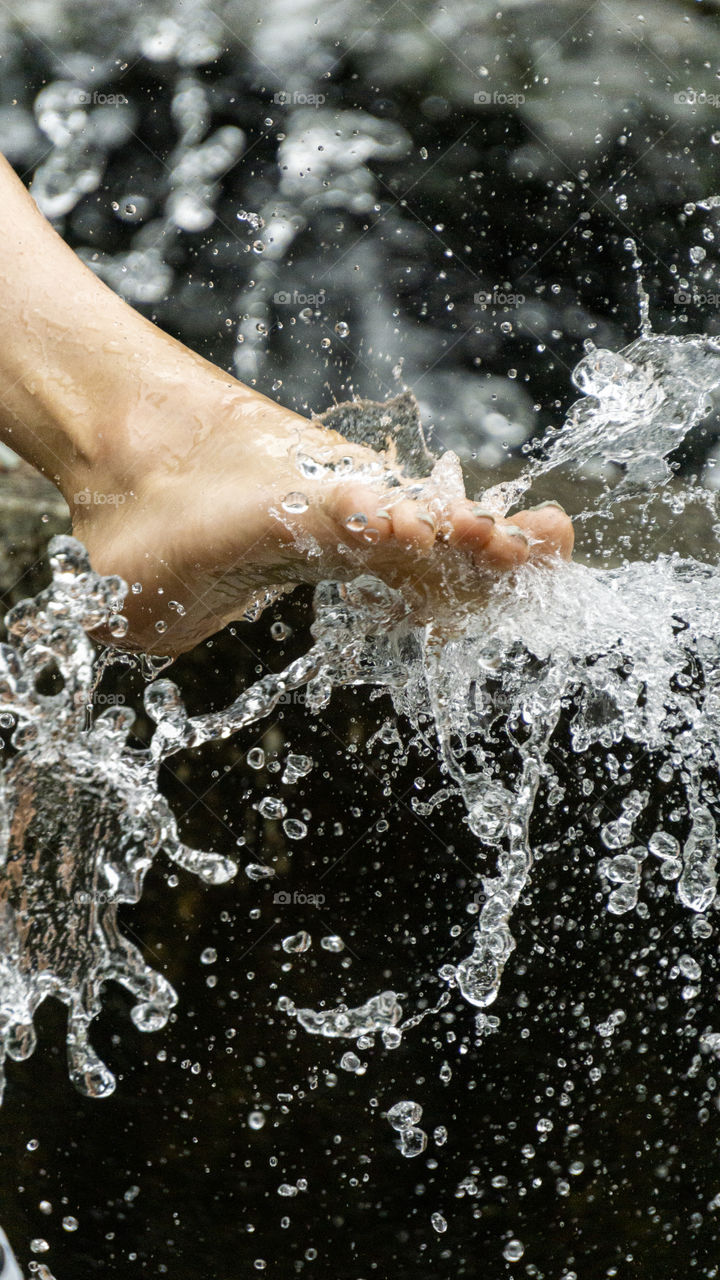 female legs under running water