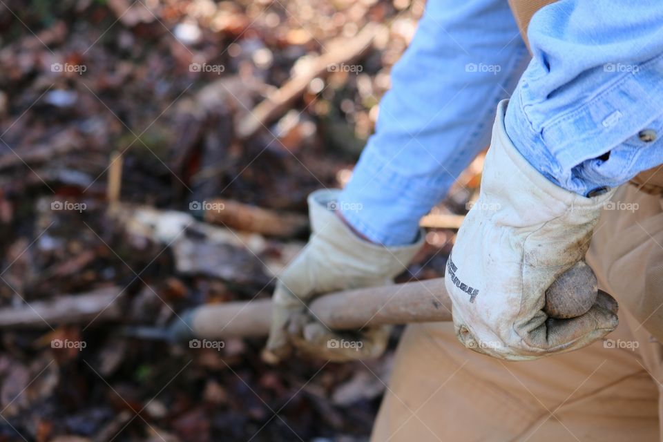 Person hand digging with showel