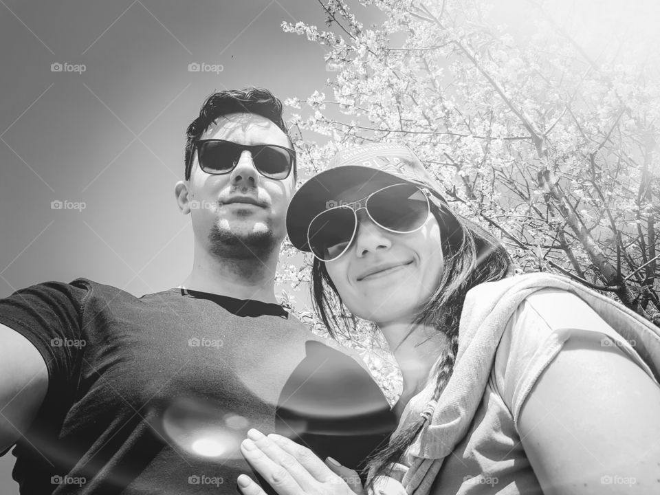 Portrait of a young couple in sunglasses in the rays of the sun.