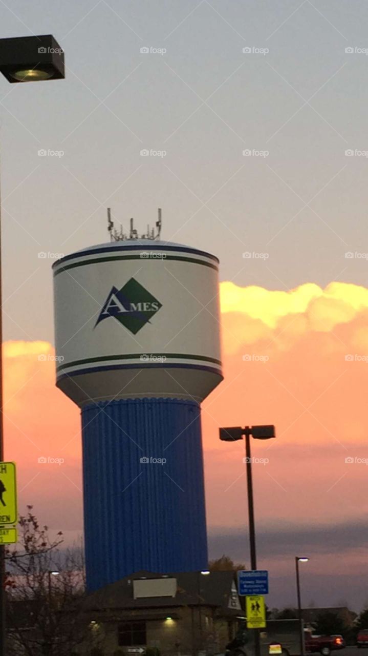 Ames iowa water tower at twilight puffy cloud skyline