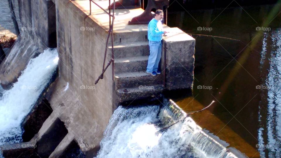 fisherman on the dam