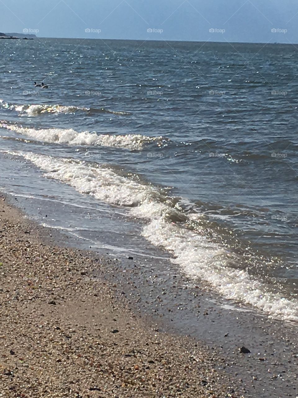 Ocean water waves on the beach.