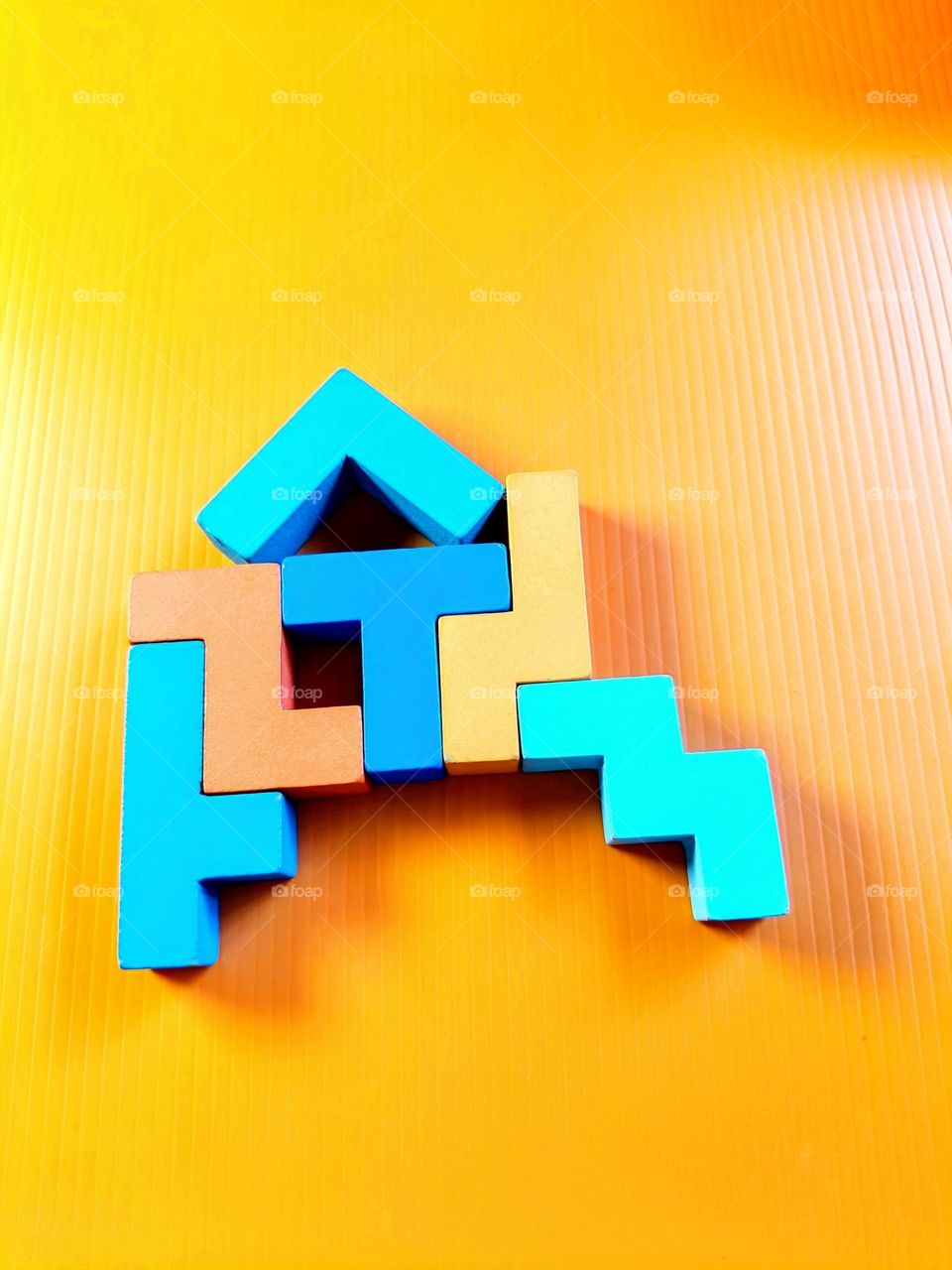 Wooden blocks on the orange backdrop.