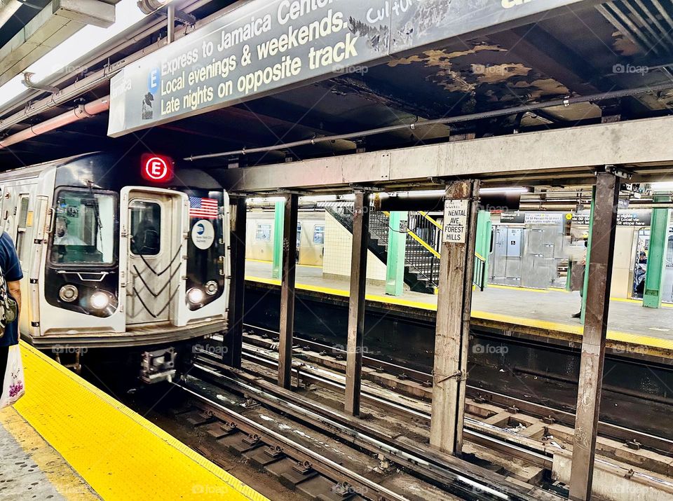 NYC Subway arriving in the station. The system operates 24/7 transporting commuters between the four boroughs. 