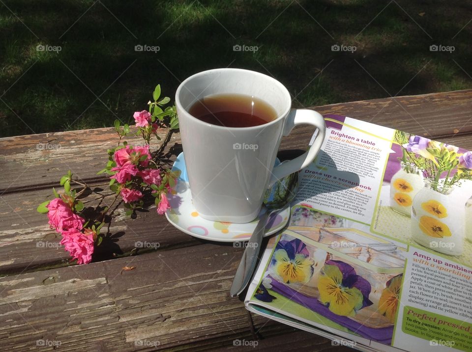 Enjoying a cup of coffee on a beautiful spring day outdoors.