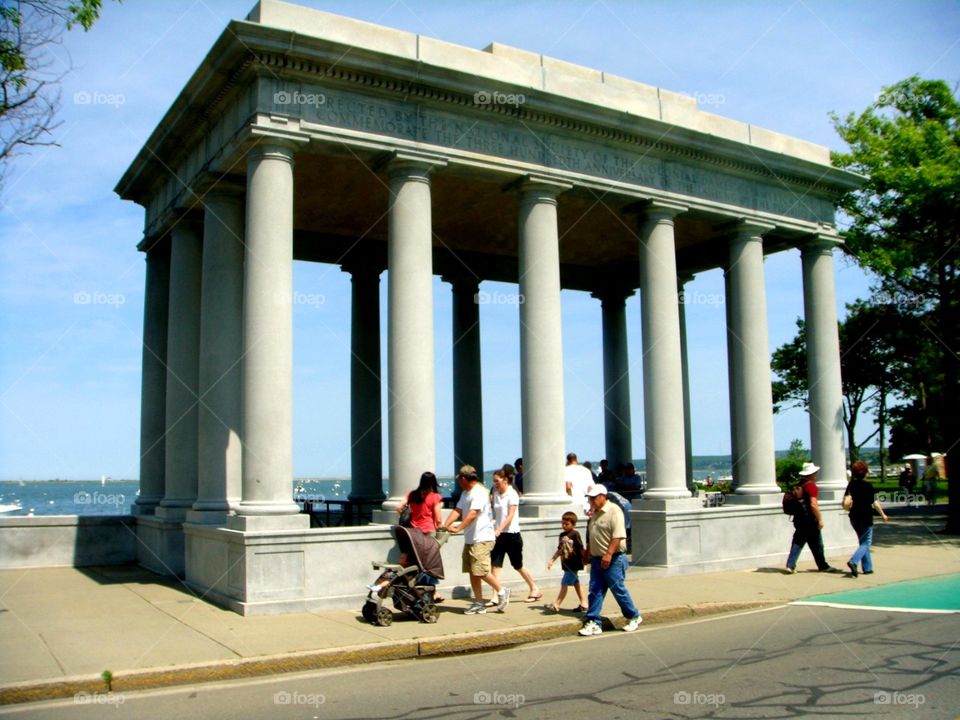 Pillars surround Plymouth Rock in Massachusetts USA. Said to be rock The Pilgrims stepped on getting off The Mayflower ship taken from England in 1620! They and Native American Indians had a harvest meal together now known as Thanksgiving Day in USA.