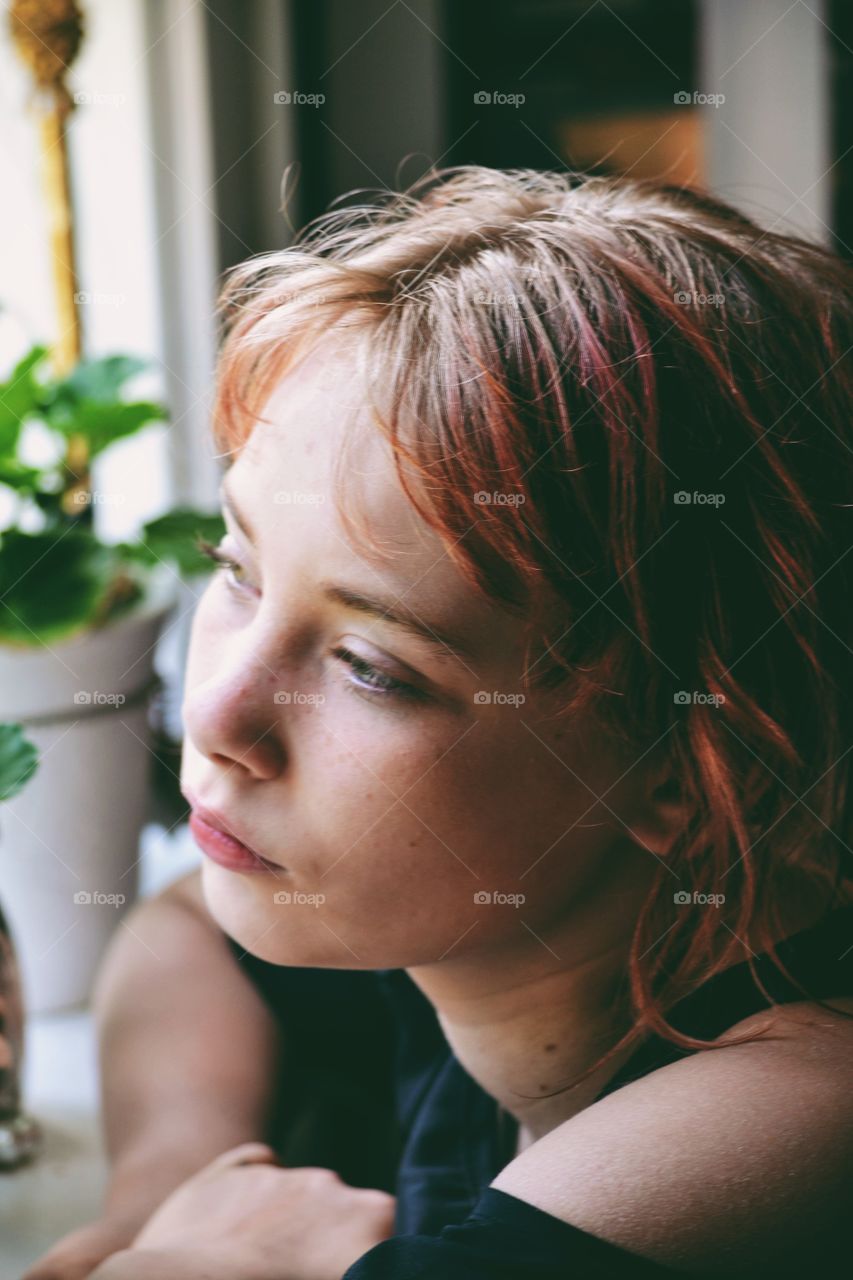 Girl looking out through a window 