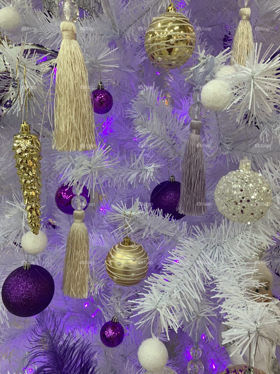 Christmas decorations. white spruce decorated in purple and gold color. Celebrate all the holidays.