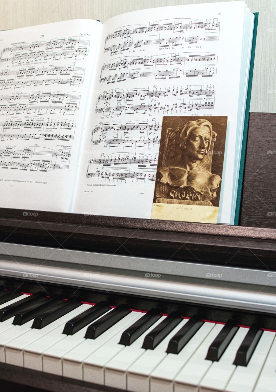 chopin postcard and sheet music on the piano