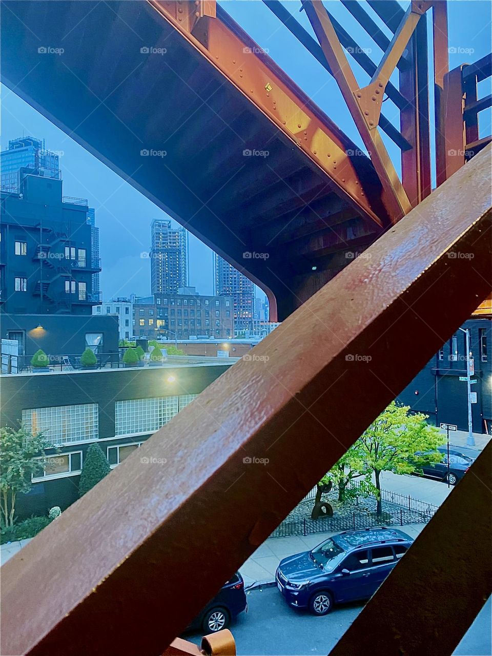 This is the red metal staircase leading up to the pedestrian lane of the „Pulaski Bridge“ in „Greenpoint“, Brooklyn. The bridge crosses over into neighboring LIC, Queens. 2023. Hypnotic Productions