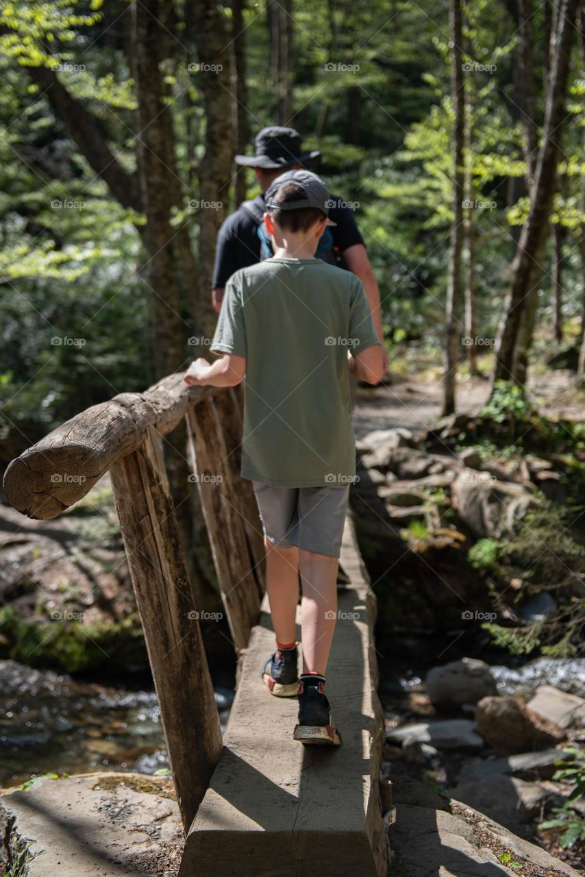 Father and son crossing a bridge on a hike in the Great Smoky Mountains national park 