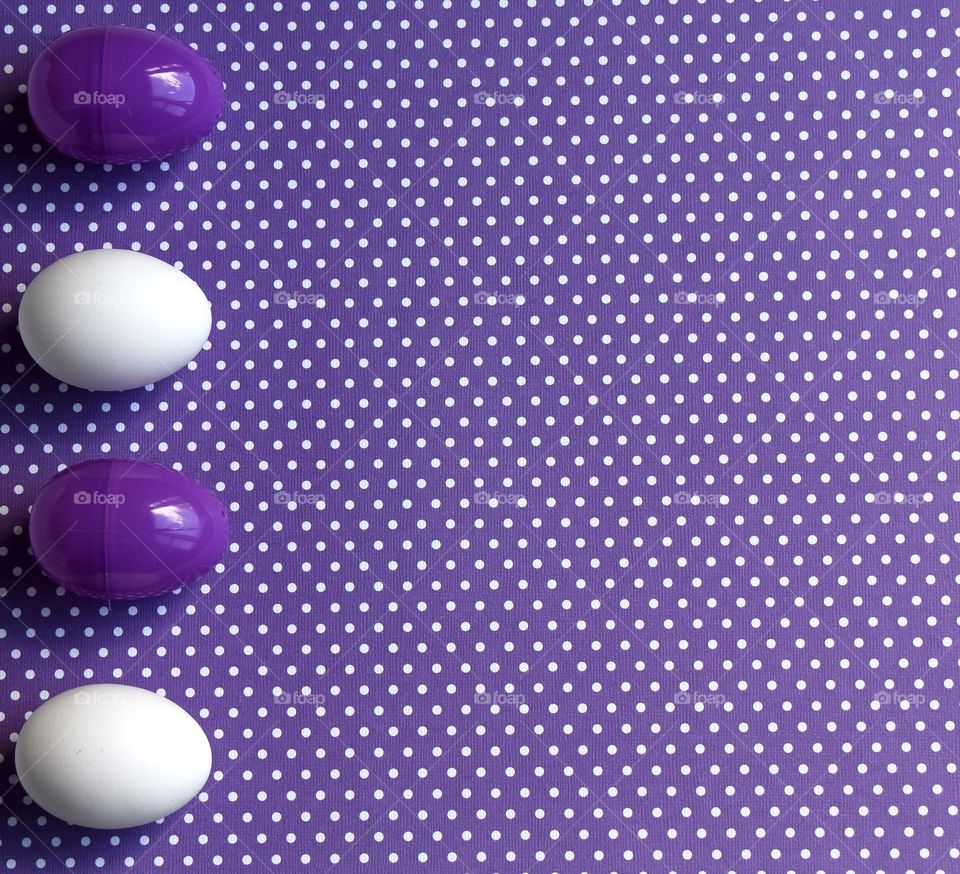 Purple and white Easter eggs on purple with white polka dots