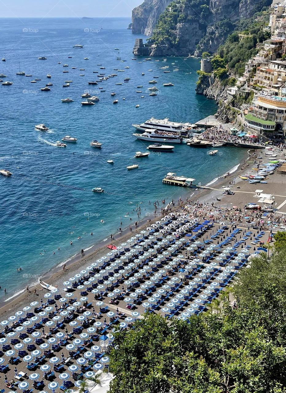 Beautiful summer beach with sun umbrellas top view 