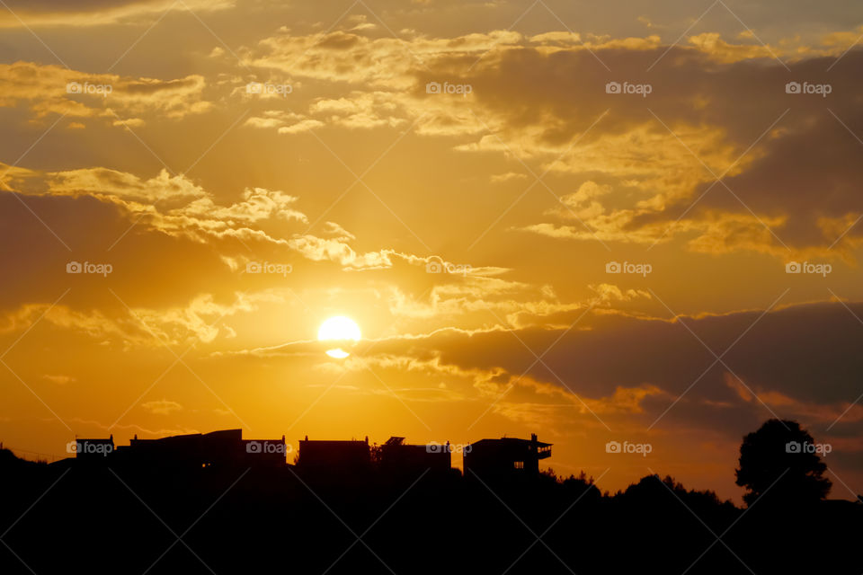 Beautiful landscape view  of sunset, cloudy sky over the village.