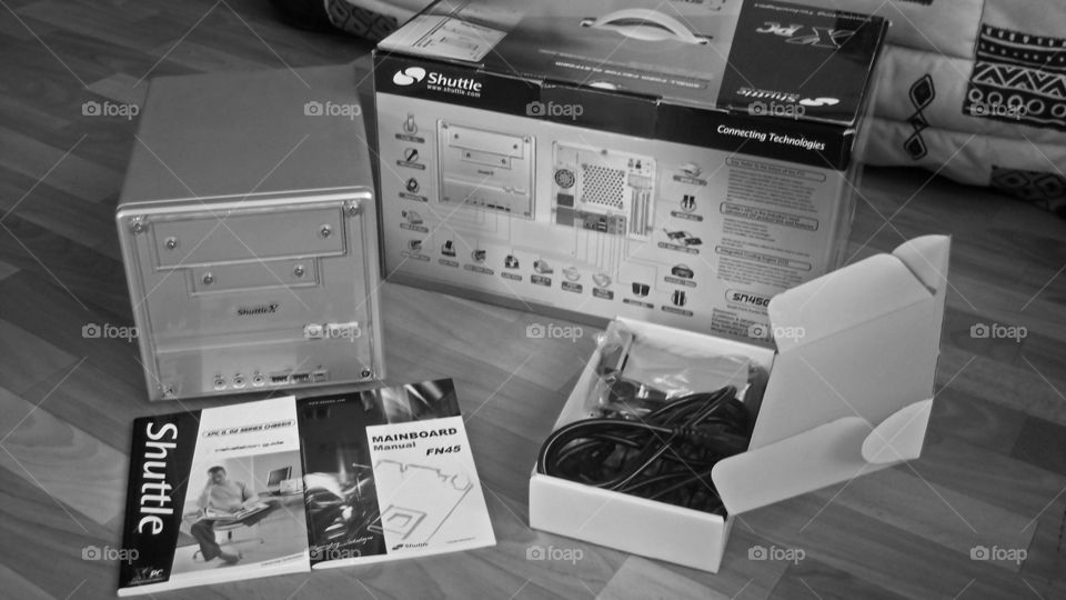 One unboxed small factor computer in a black and white photography