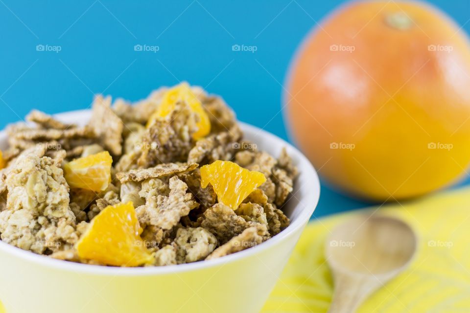 bowl full with cereals and fruits. white bowl full with crunchy cereals and fruits