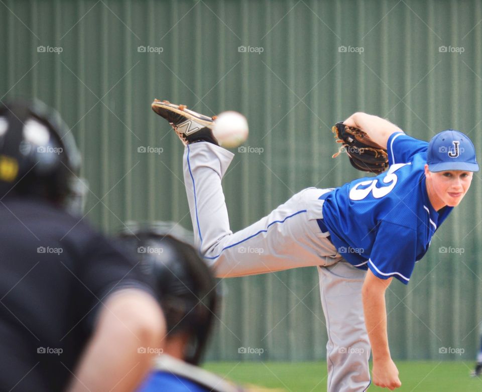 Pitcher throwing baseball