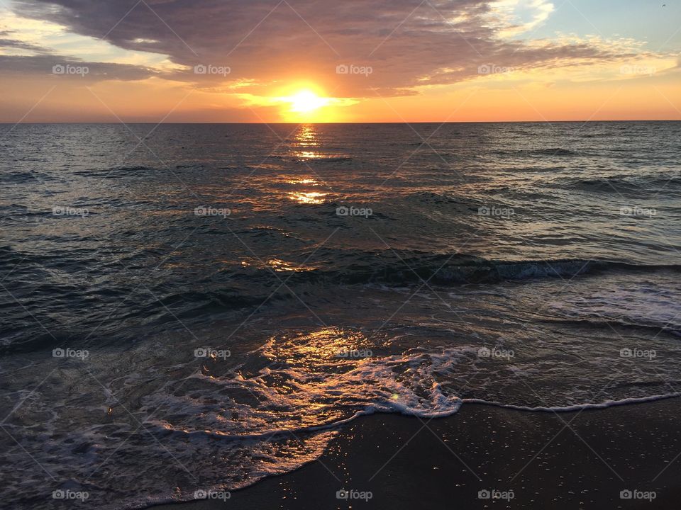 Ocean waves at sunset.