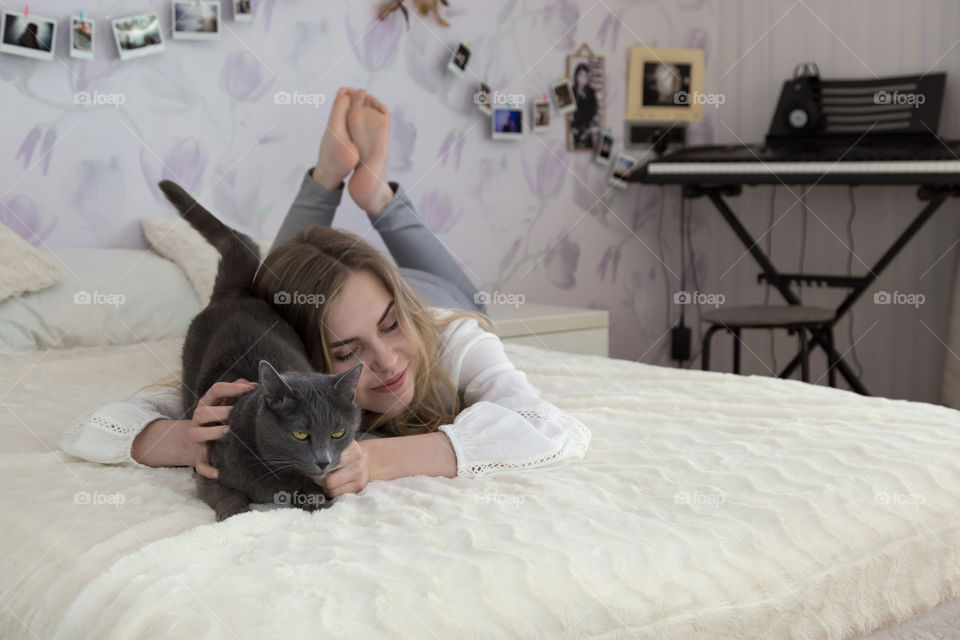 girl with cat in bedroom
