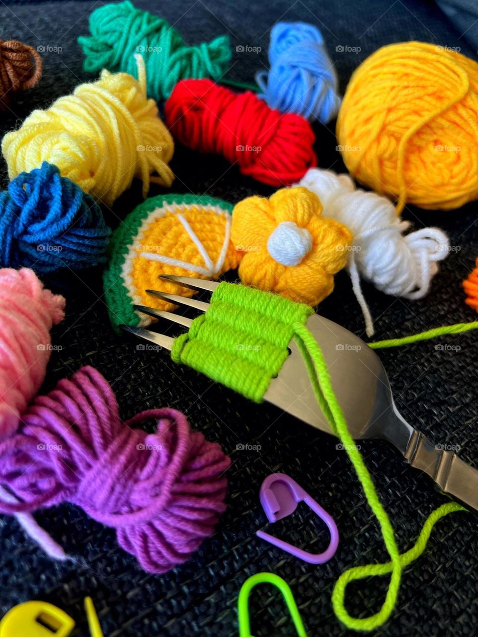 A fork with colorful woolen yarn.