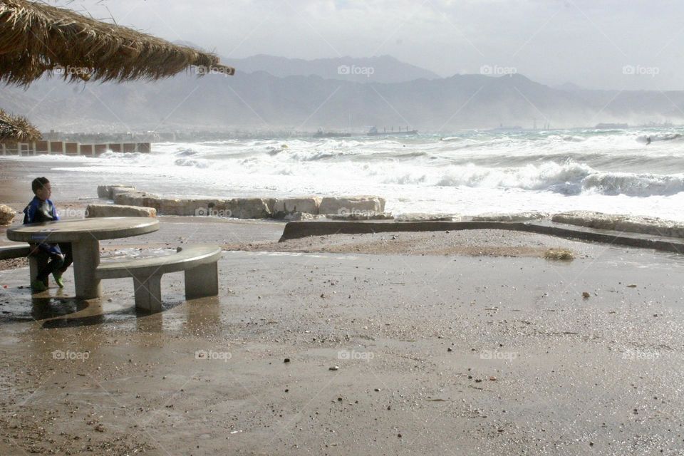 Big storm over the Red Sea usually calm sea without waves. In this storm the sea became very high and the big waves arrived and washed the beach and promenade 