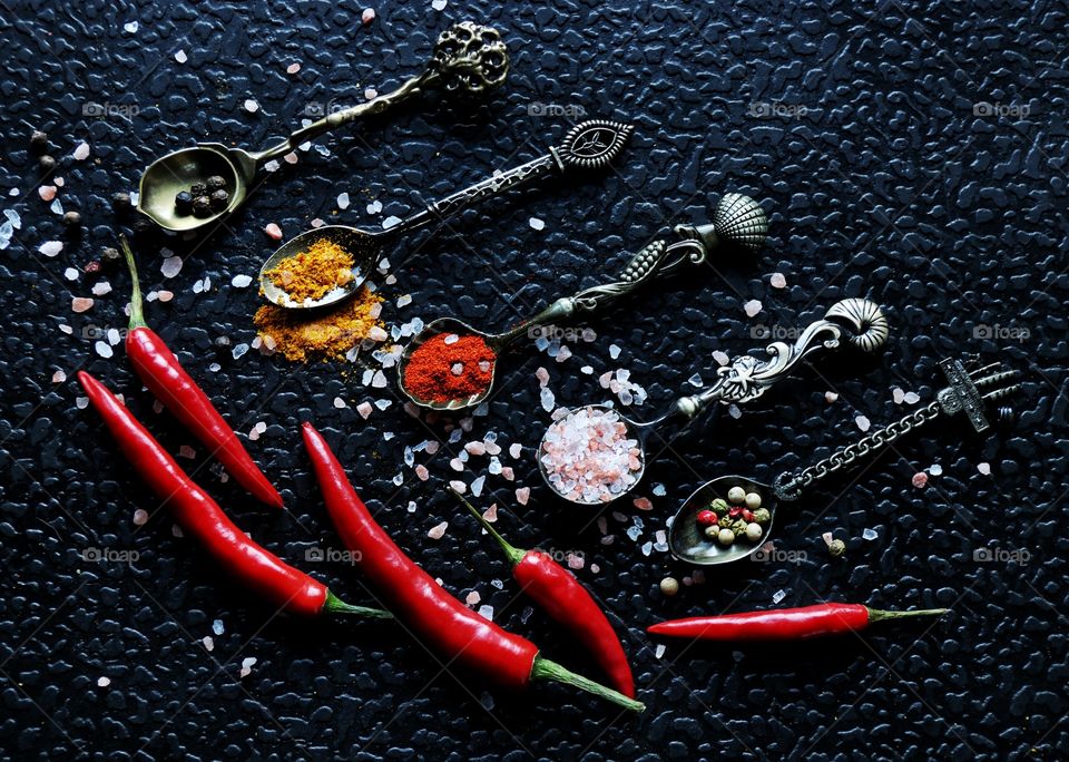 red hot peppers and spices in vintage spoons